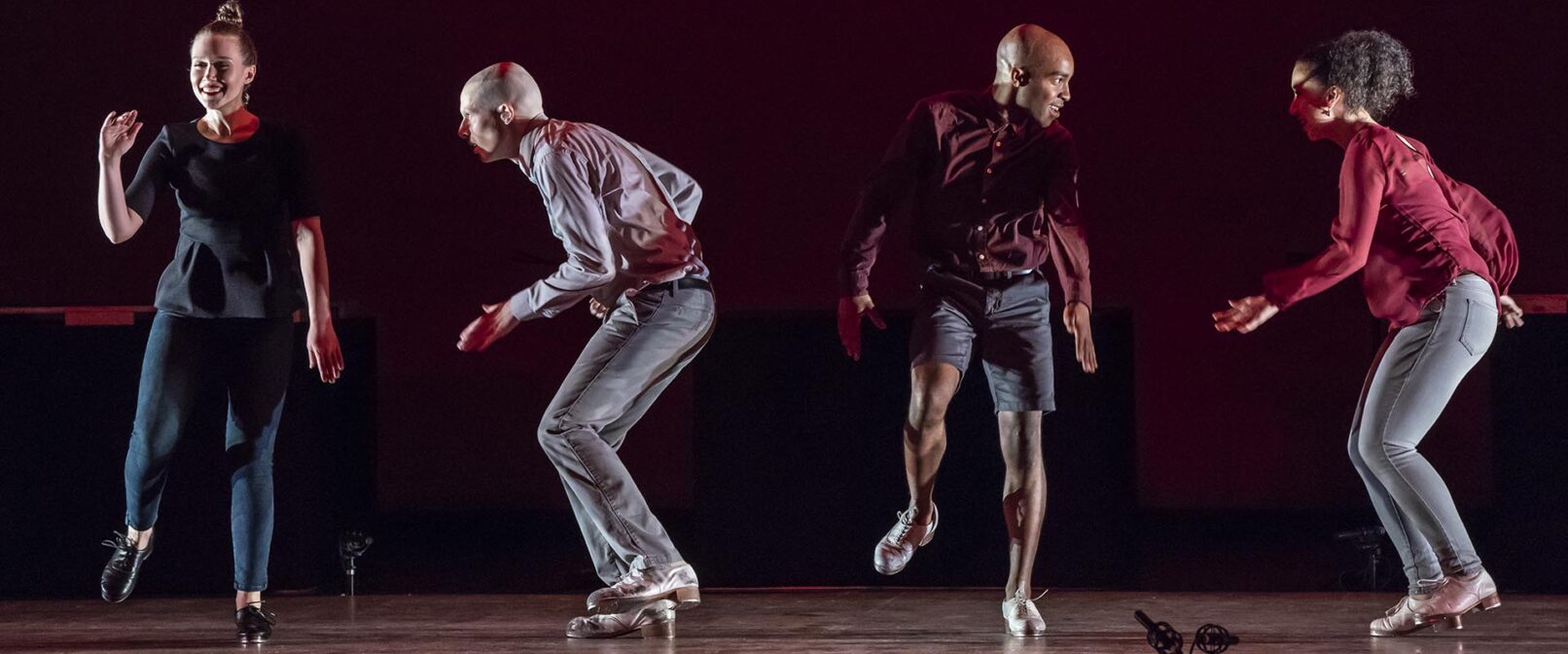 Dorrance Dance. SOUNDspace. Two men and two women, all in tight pants and solid colour tops, tap dance in a row. Two face the camera, and alternating between them two face to the left.