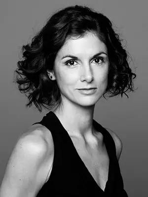 Agustina Videla (Argentina) 4 Agustina Videla. A black and white portrait of a fair skinned woman with chin length curly dark hair, wearing a sleeveless black top.